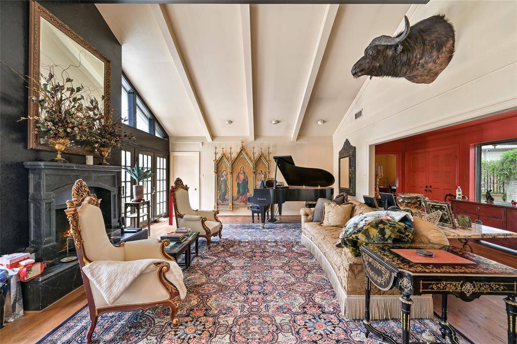 This grand living room features vaulted ceilings, dramatic beams, and designer finishes, creating a regal yet comfortable space for everyday living or upscale entertaining.