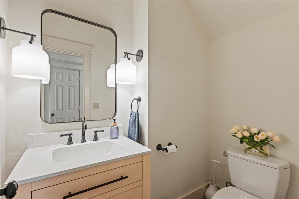 Classically designed downstairs powder bath, featuring timeless fixtures and a refined, elegant look
