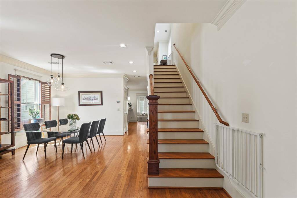 Front entry view facing the dining room and wood staircase, showcasing a warm, welcoming layout with classic architectural details