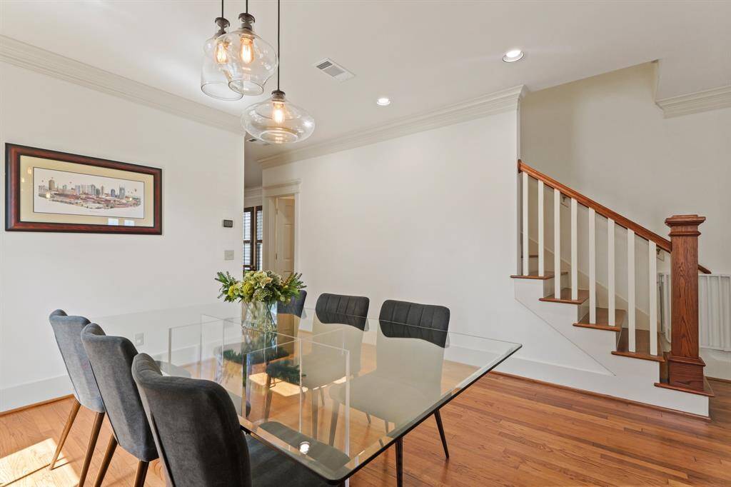 Dining area with view of the elegant wood staircase—perfect blend of style and flow