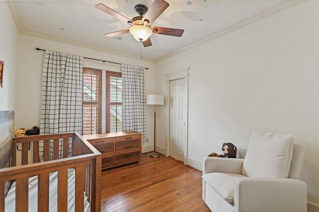 Spacious bedroom with large windows, offering plenty of natural light.