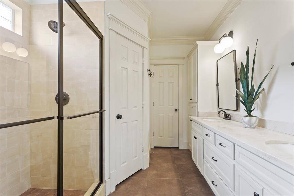 Primary bathroom featuring a stylish vanity, modern fixtures, and a spacious layout for both comfort and functionality