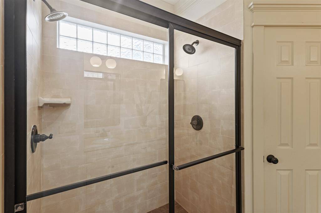 Extra-large shower with dual showerheads, providing a luxurious and spacious experience for ultimate comfort