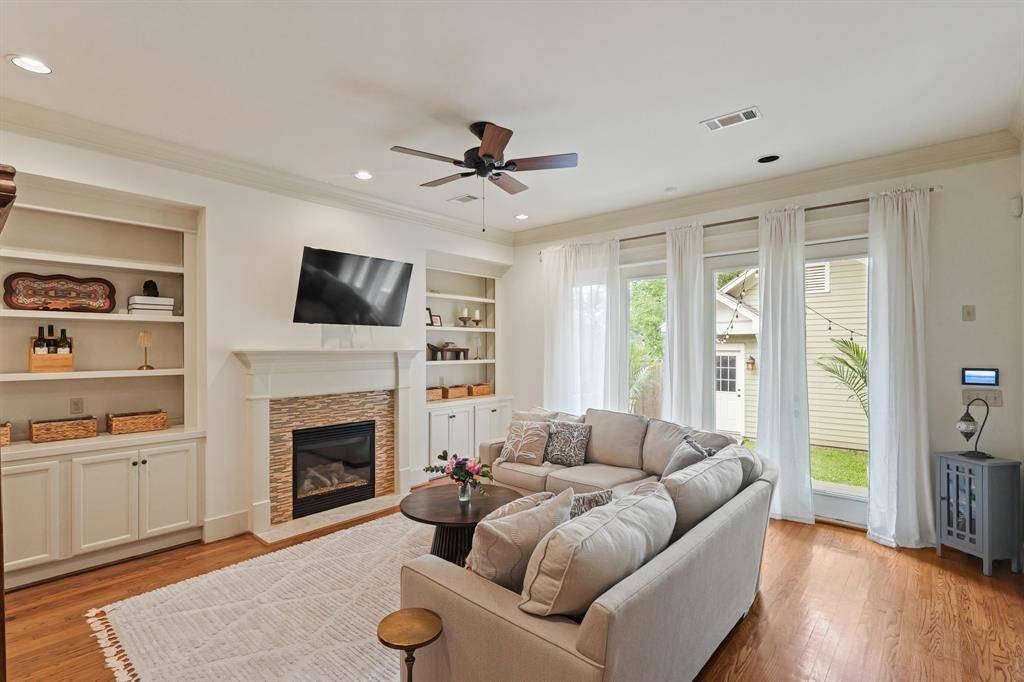 Spacious living room with built-in shelves and a fireplace that adds both warmth and character to the space.