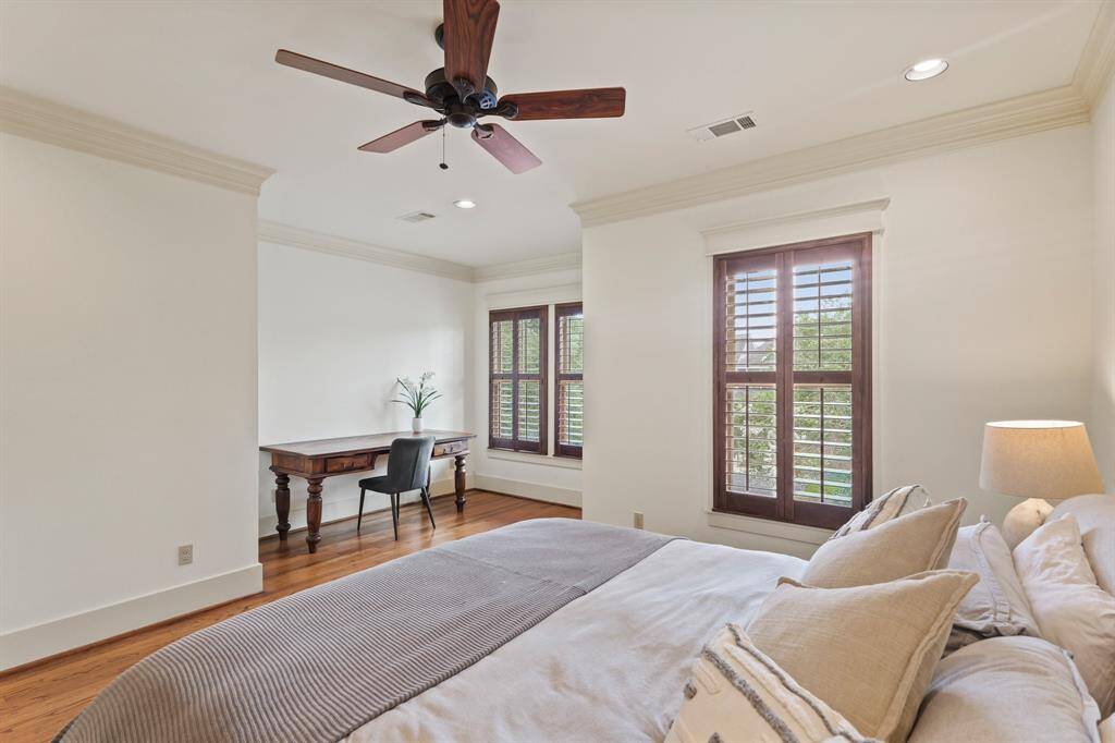 Primary bedroom featuring elegant plantation shutters, adding a touch of sophistication and allowing for adjustable natural light