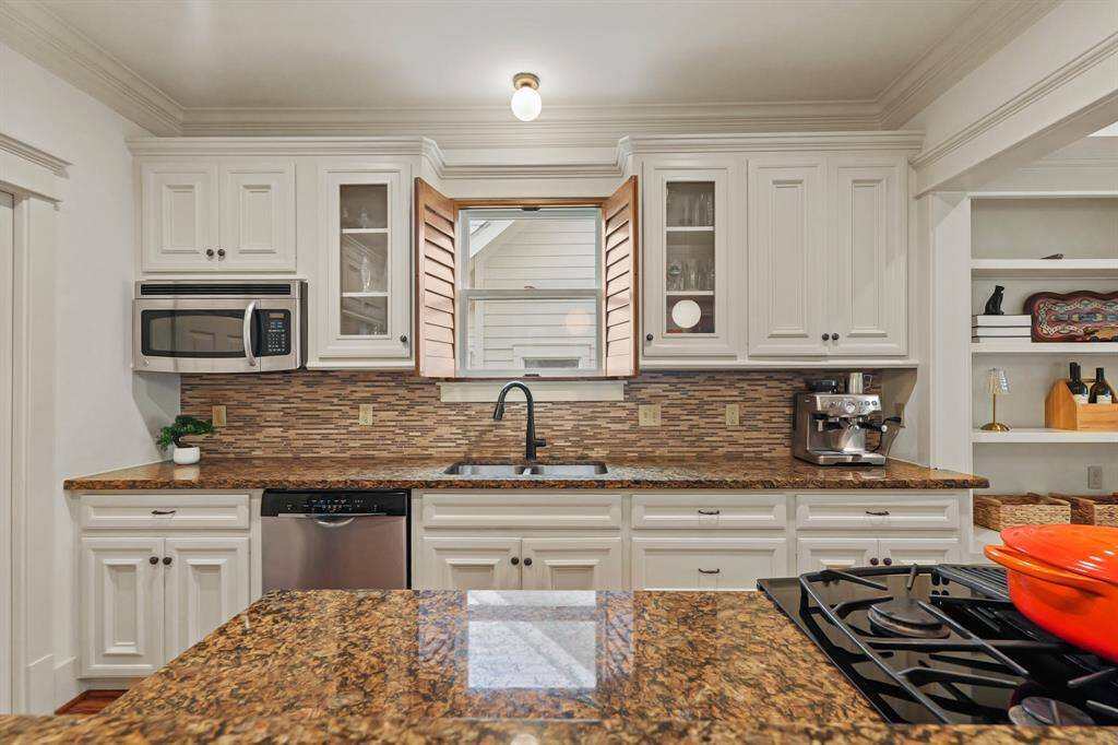 Over the sink window with plantation shutters, offering natural light and a touch of elegance.