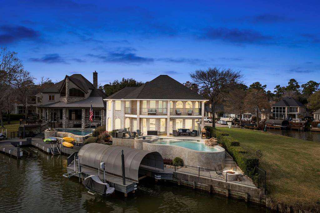Discover the epitome of lakeside luxury in this stunning two-story home, nestled within a secure, gated community. Bask in breathtaking sunrise views from your private balcony or enjoy leisurely afternoons by the heated pool and spa. With a dedicated boat and jet ski lift, lake adventures are just a heartbeat away. Embrace the ultimate lifestyle!