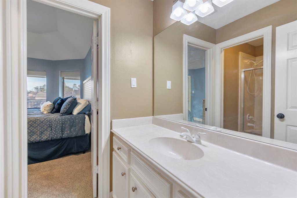 Step into this elegantly designed secondary bathroom, seamlessly connected to a cozy bedroom retreat.