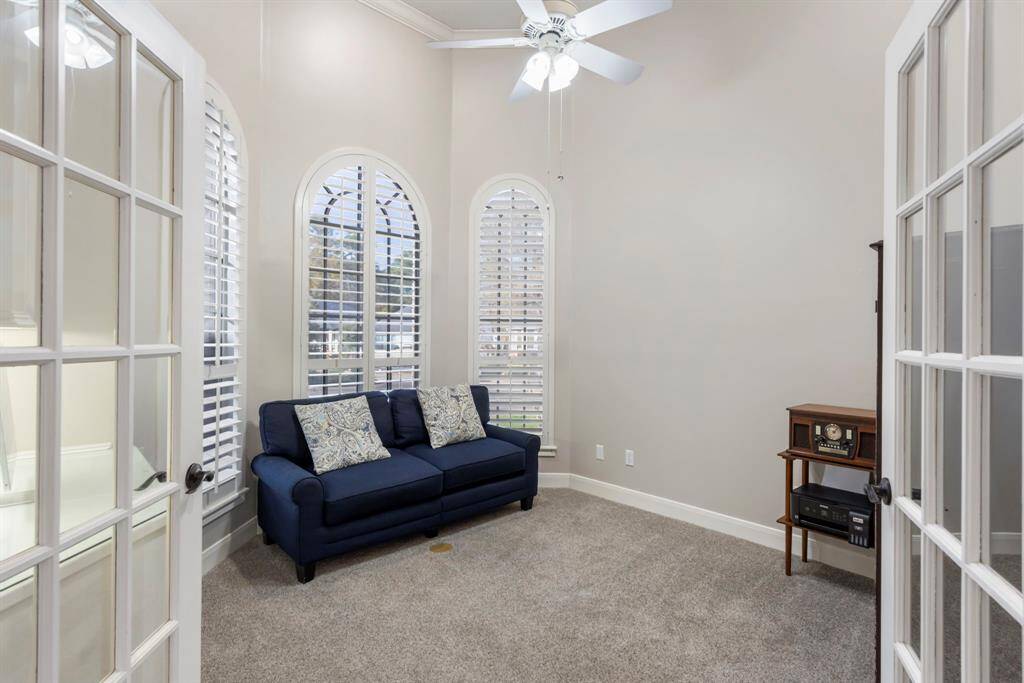 This charming freshly painted study, with its plush carpeting and French doors, offers the perfect blend of style and privacy. Imagine cozy afternoons with a good book or productive mornings.
