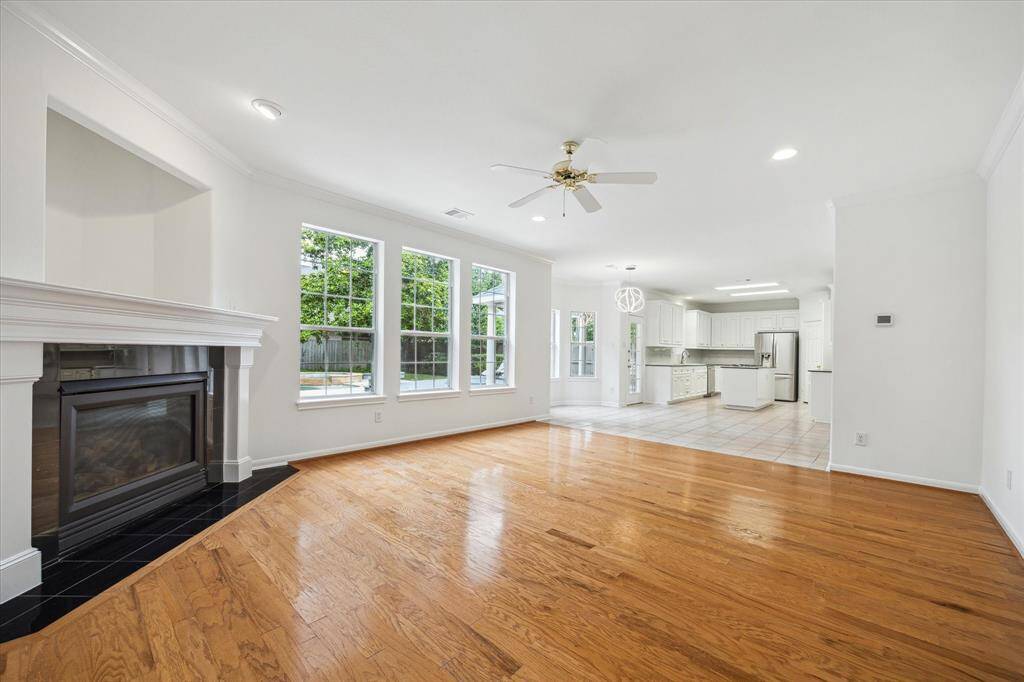 The open plan layout seamlessly connects the family room to a kitchen filled with natural light.
