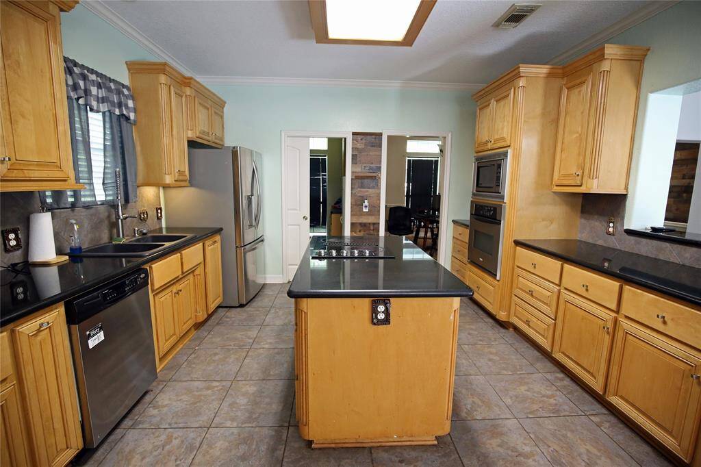 The kitchen opens into the Living Room, the Utility Room to the left and the Dining Room.