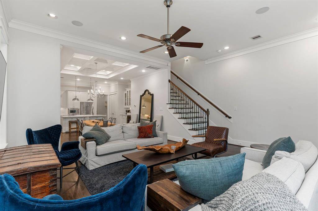 From this perspective, you can admire the home's seamless flow and the staircase, complete with hardwood treads that harmonize with the matching banister and iron railing.