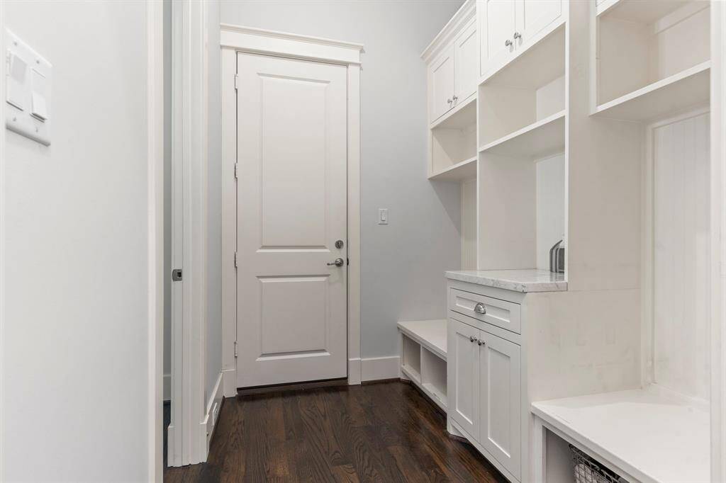 Entering from the garage, the mudroom provides a convenient spot to remove shoes, store backpacks, and hang coats before heading into the kitchen.