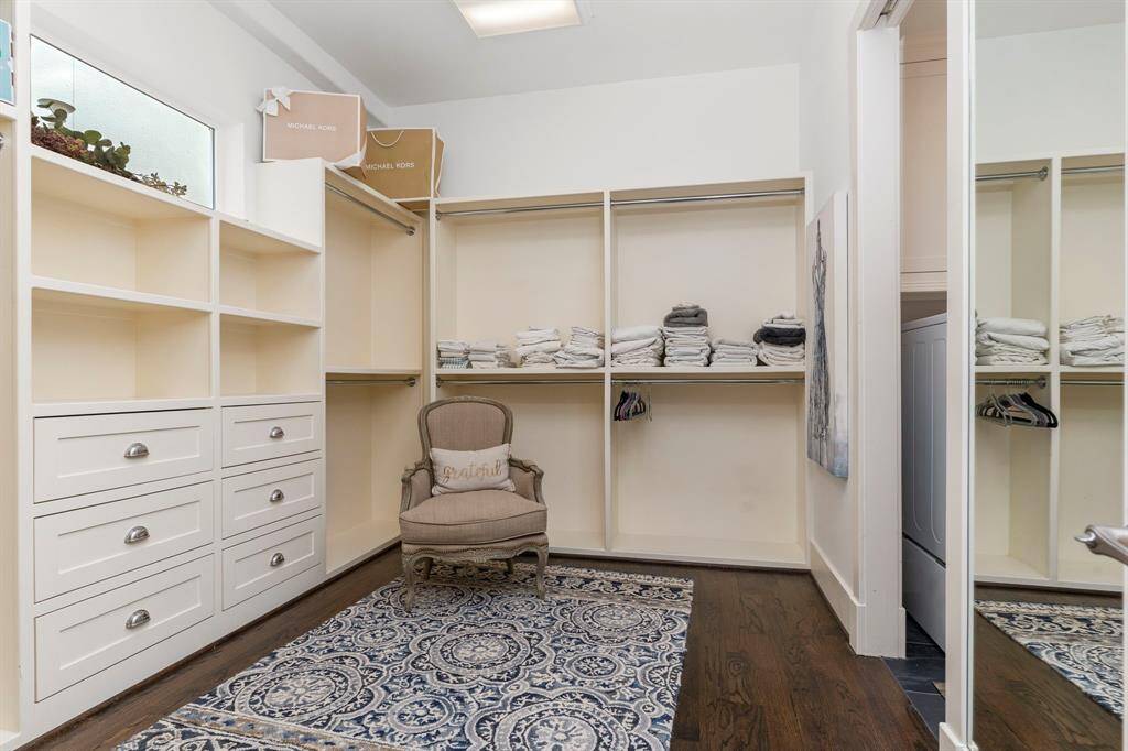 Primary closet featuring built-in shelving and storage.
