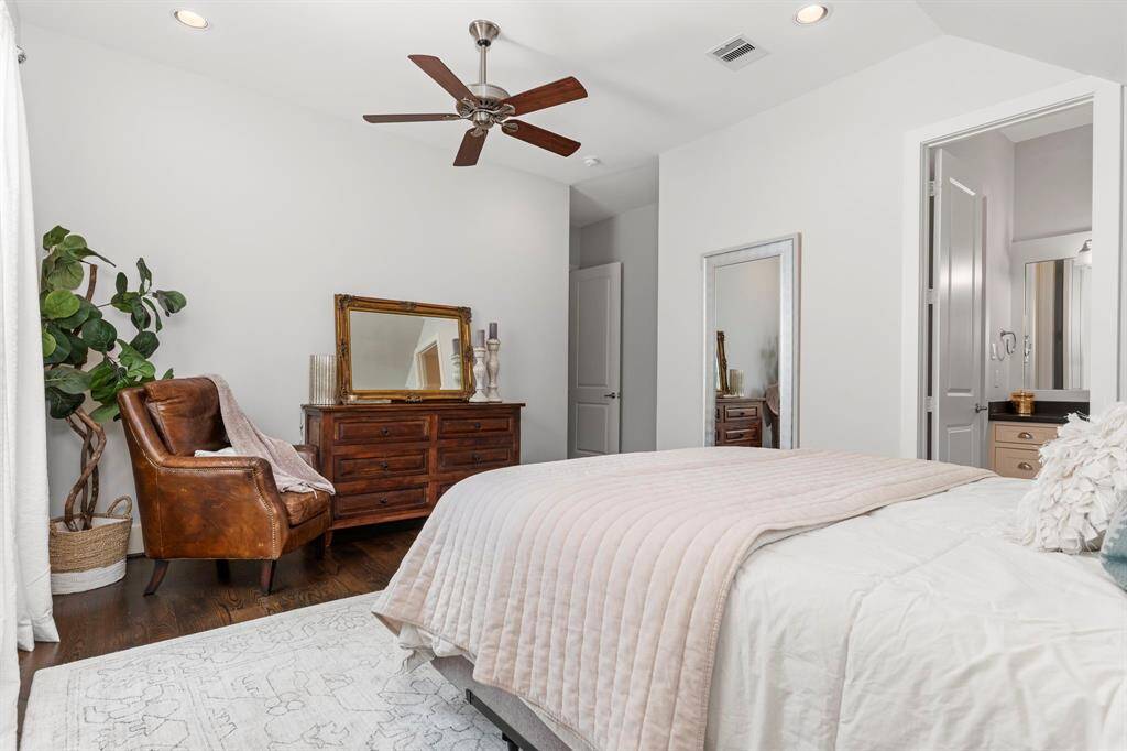 The charming fourth bedroom features a sloped wall, recessed lighting, a ceiling fan, and a lovely ensuite bathroom.