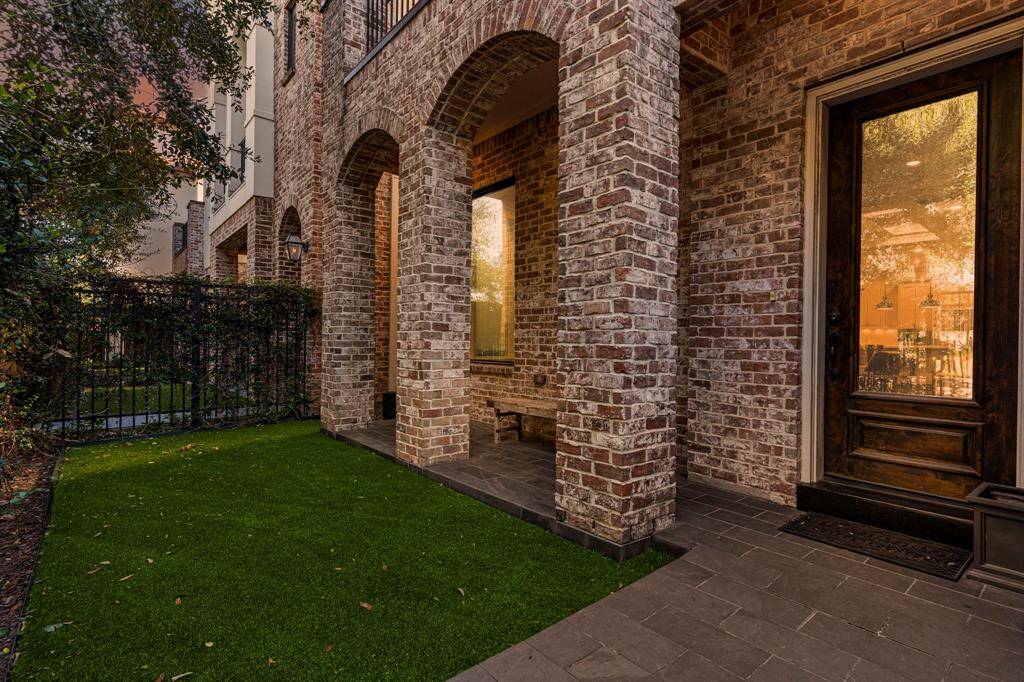 The gated entrance boasts vibrant and lush landscaping, enhancing the property's appeal. The convenience of additional guest parking at the front of the home is so nice!