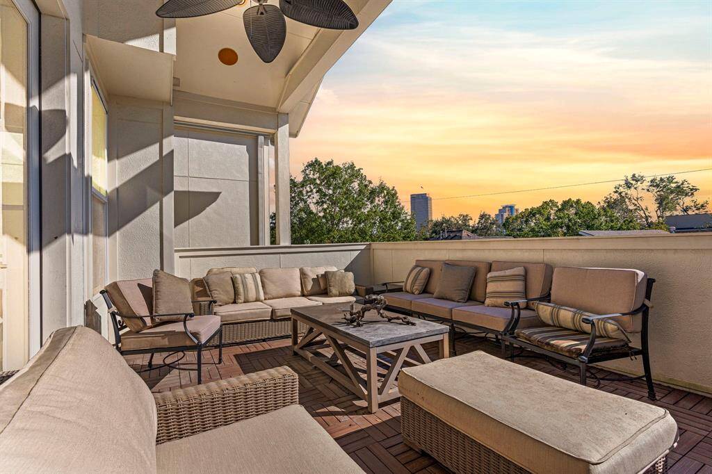 Whether you're relaxing or entertaining, this impressive rooftop balcony next to the game room offers ample seating space and a large ceiling fan for added comfort. *Virtually edited sky*