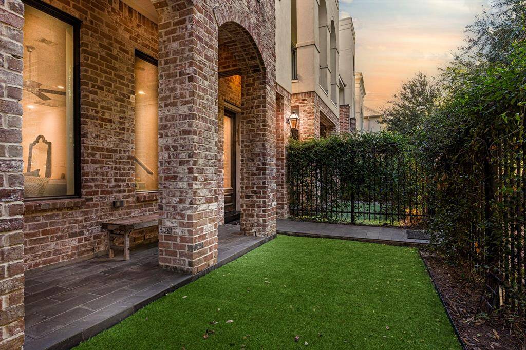 This alternate view of the covered front patio highlights the ample space for outdoor relaxation and offers a picturesque look at the front green space.