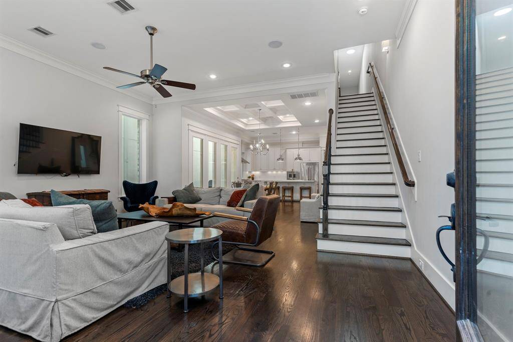 Stepping through the front door with its elegant glass insert, you'll be welcomed by beautiful wood floors and interiors filled with natural light.