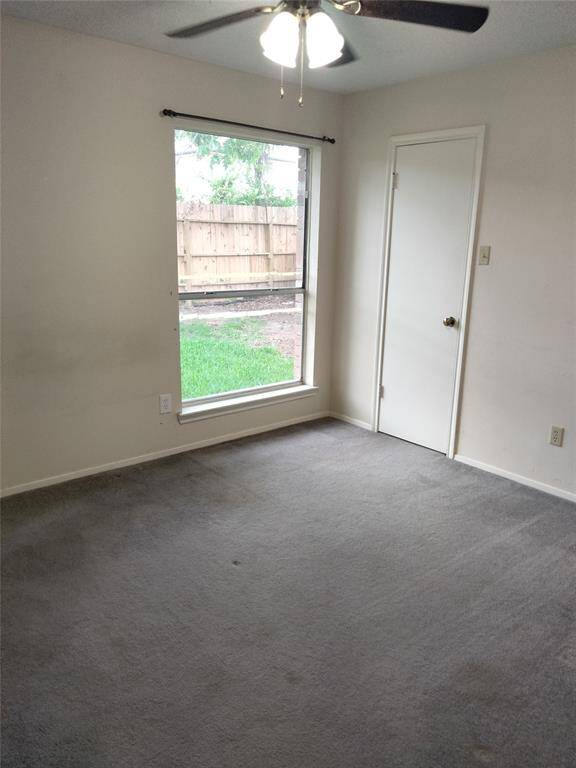 Another downstairs non primary bedroom, all bedrooms have ceiling fans with lights and have lots of natural light.