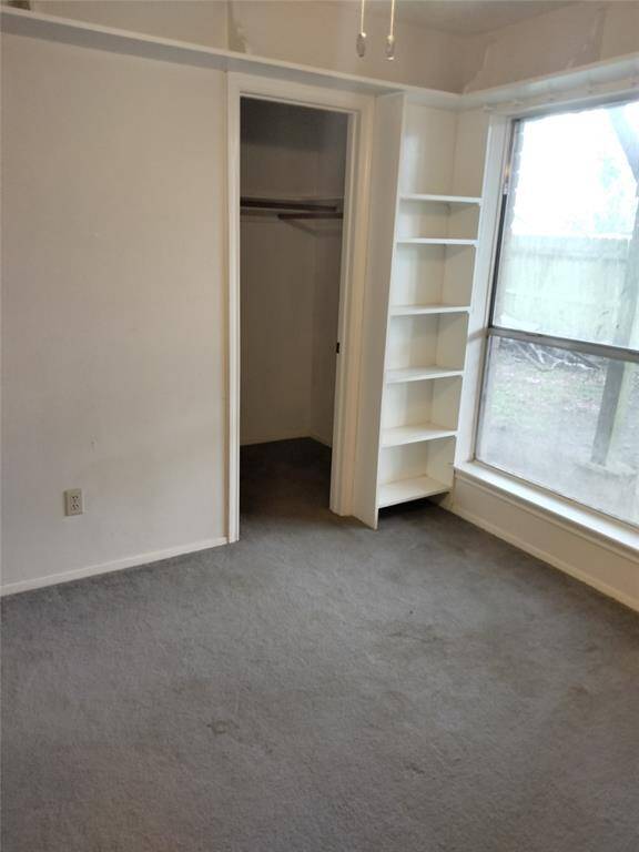 Note built in shelving and walk in closet in downstairs bedroom.