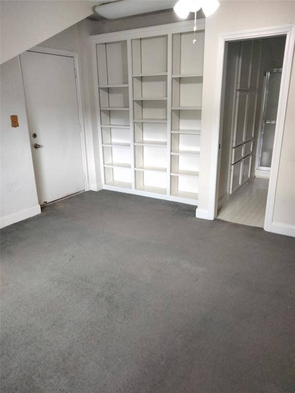 Upstairs bedroom has tons of shelving a private patio and full bath.