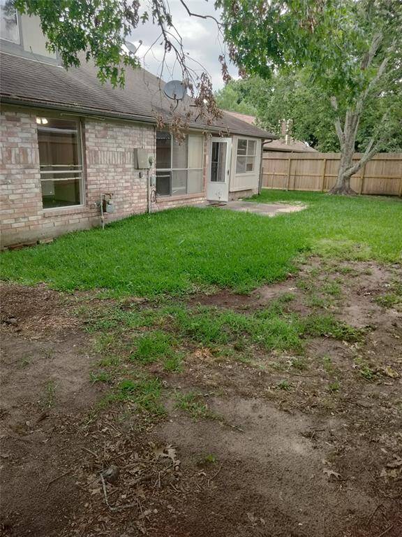 Another view of fully fenced backyard, perfect for dogs.
