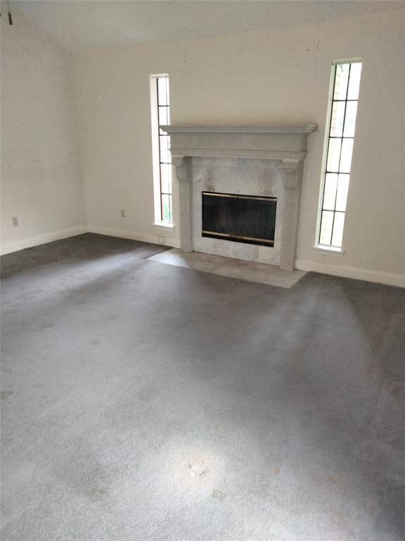 Formal living area features a beautiful fireplace with large mantle.