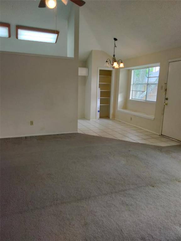 Den has tall ceilings and contains spiral staircase and also opens to breakfast area and access to backyard.