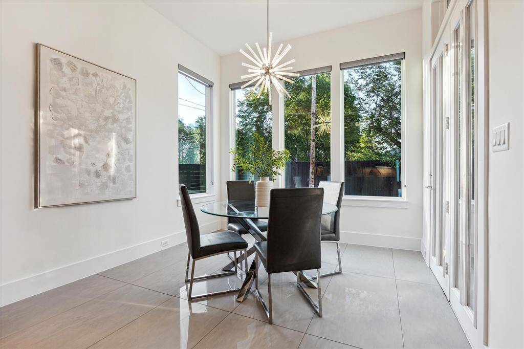 [MORNING ROOM] Bathed in natural light and thoughtfully positioned just off the kitchen, the morning room offers a serene spot to start your day. Expansive windows frame peaceful views of the outdoors, creating a bright and uplifting atmosphere for casual dining or a quiet cup of coffee.