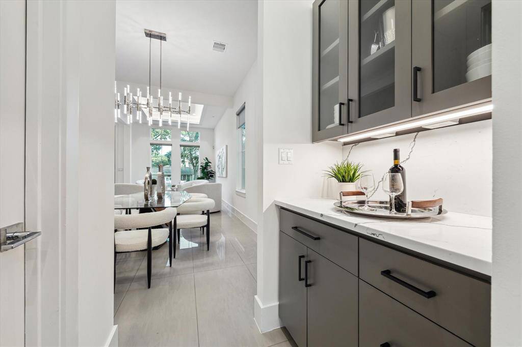 [BUTLER'S PANTRY] Tucked perfectly between the kitchen and dining room, the butler’s pantry offers a seamless transition for effortless entertaining and everyday convenience. With sleek cabinetry, ample storage, and thoughtfully designed prep space, it serves as both a functional workspace and elegant extension of the kitchen.