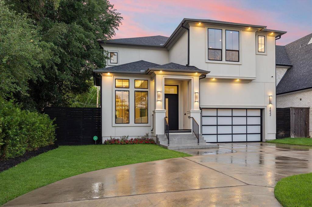 The clean architectural lines are enhanced by a mix of smooth stucco and stone accents, expansive windows, and a sleek flat or low-pitched roofline. Beautifully landscaped grounds enhance the striking curb appeal.