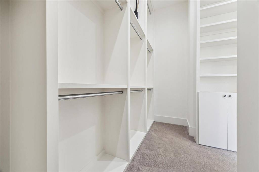 [GUEST CLOSET] The in-law suite’s walk-in closet is a true standout, offering expansive space and thoughtful design that rivals that of a second primary suite. With custom shelving and ample hanging space, it’s perfectly suited for both organization and storage, providing a luxurious experience for your guests or family members.
