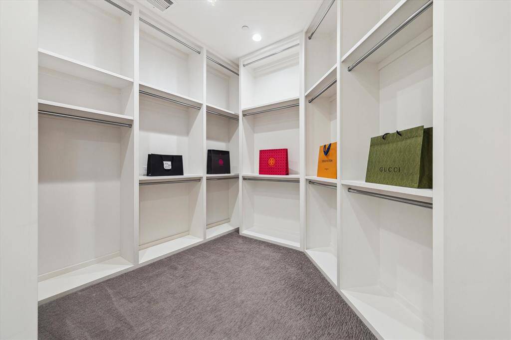 With premium finishes and tailored storage options, this walk-in closet provides both functionality and luxury—ensuring every item has its place while maintaining an effortlessly chic aesthetic.