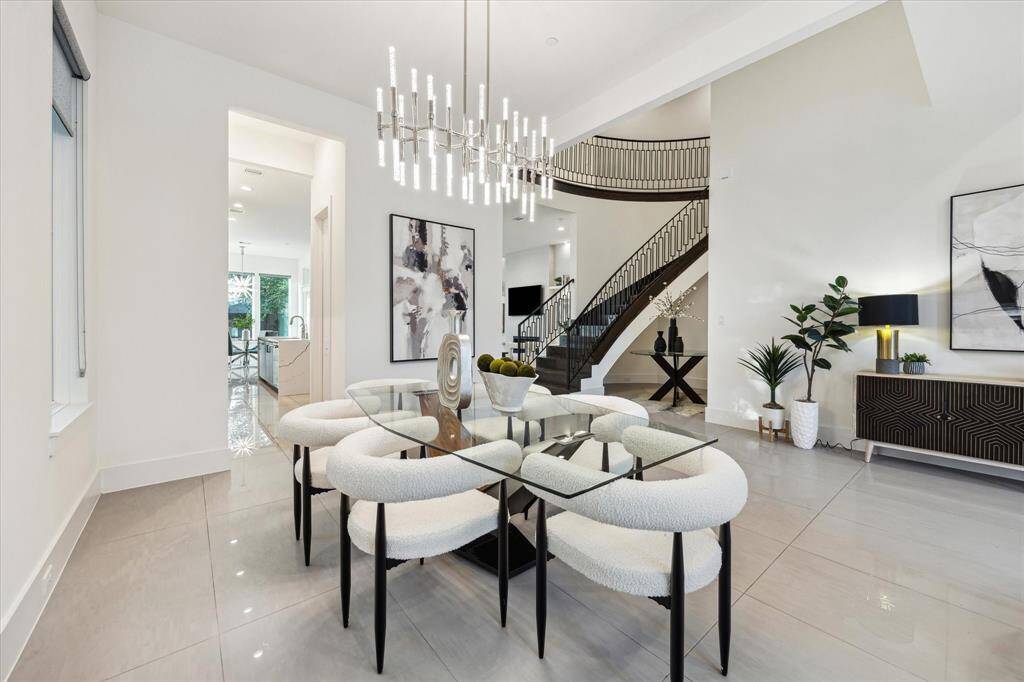 [DINING ROOM]  With clean lines, expansive sightlines, and abundant natural light, this space invites both casual meals and formal gatherings. Whether hosting a dinner party or enjoying a quiet evening in, the dining area offers the perfect balance of style and functionality in a contemporary setting.