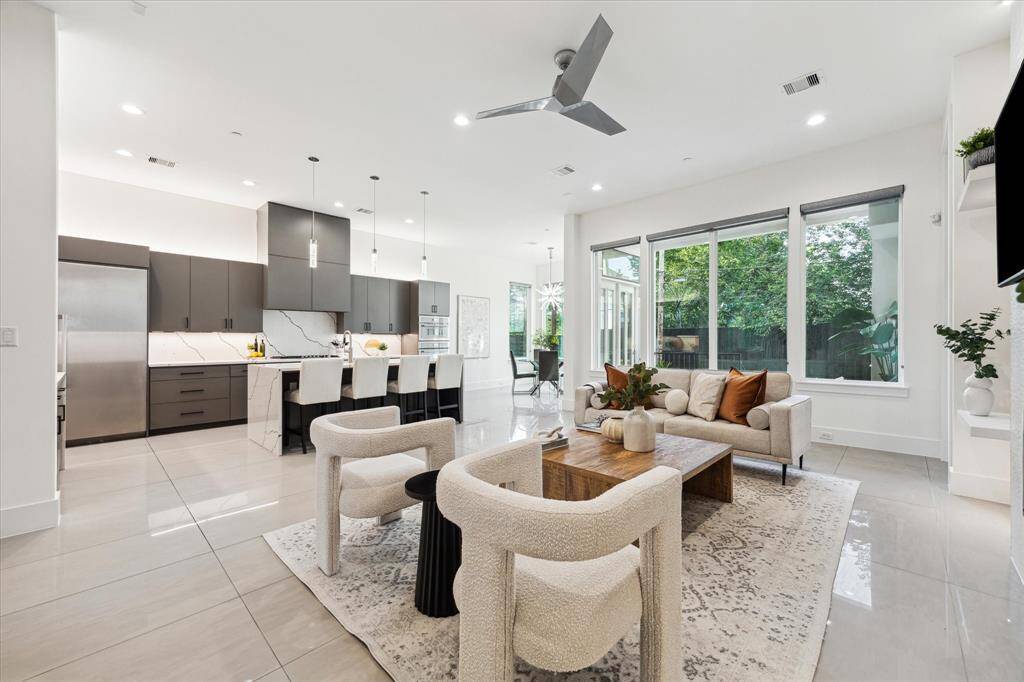 Bright, open, and beautifully connected, the family room flows seamlessly into the kitchen and breakfast areas—creating the ideal layout for modern living. Bathed in natural light from expansive windows, the space feels airy and inviting, perfect for both relaxed mornings and lively evenings.