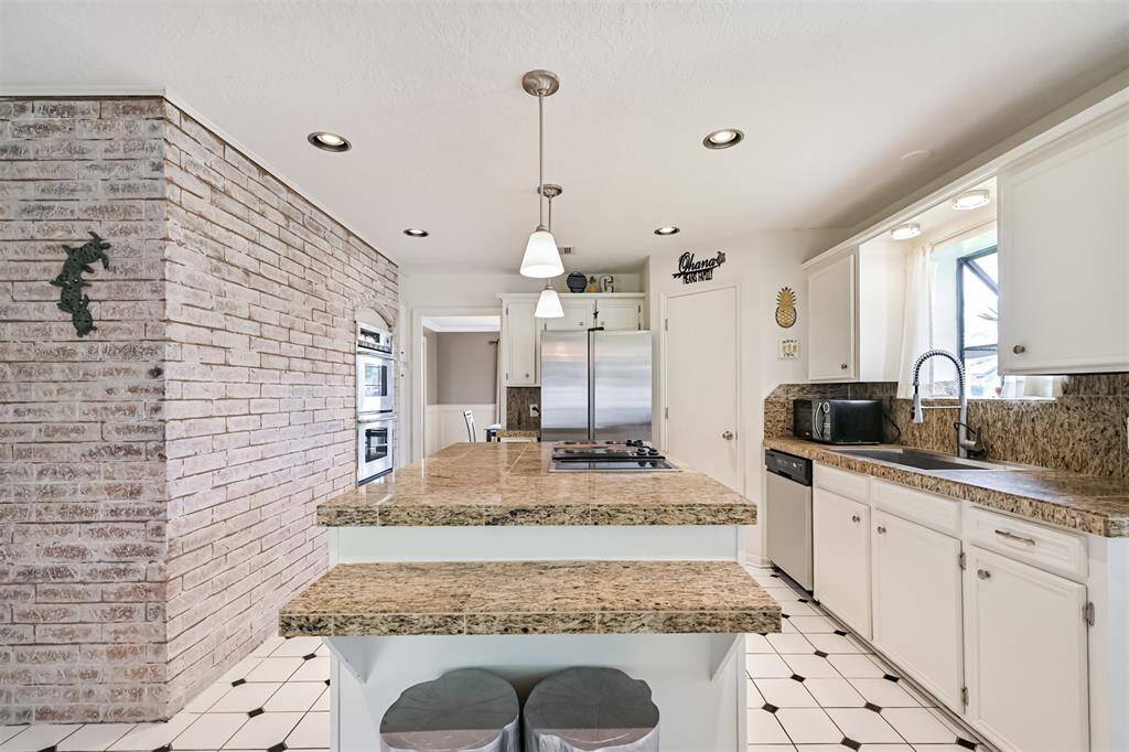 Brick accent wall with double ovens = charm + function
