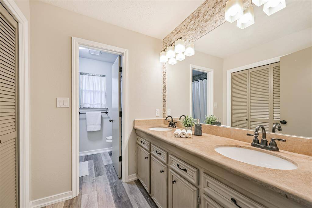 Dual-sink vanity with tons of counter space. Separate room for shower/tub combo adds privacy.