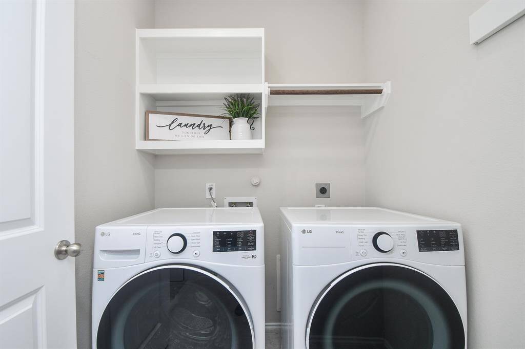 This laundry room features, open shelving for storage, and a hanging rod for convenience in a compact space.