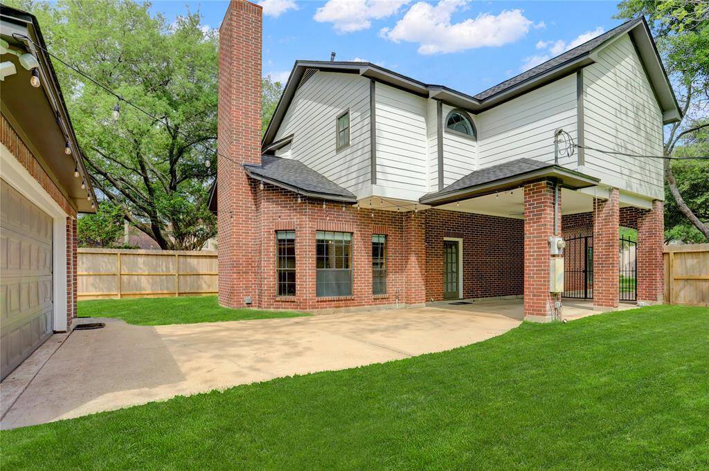 The expansive backyard allows for play space on both sides of the garage.