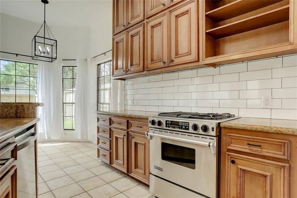The Kitchen features all stainless steel appliances, recent subway tile backsplash, a walk-in pantry and tons of storage.