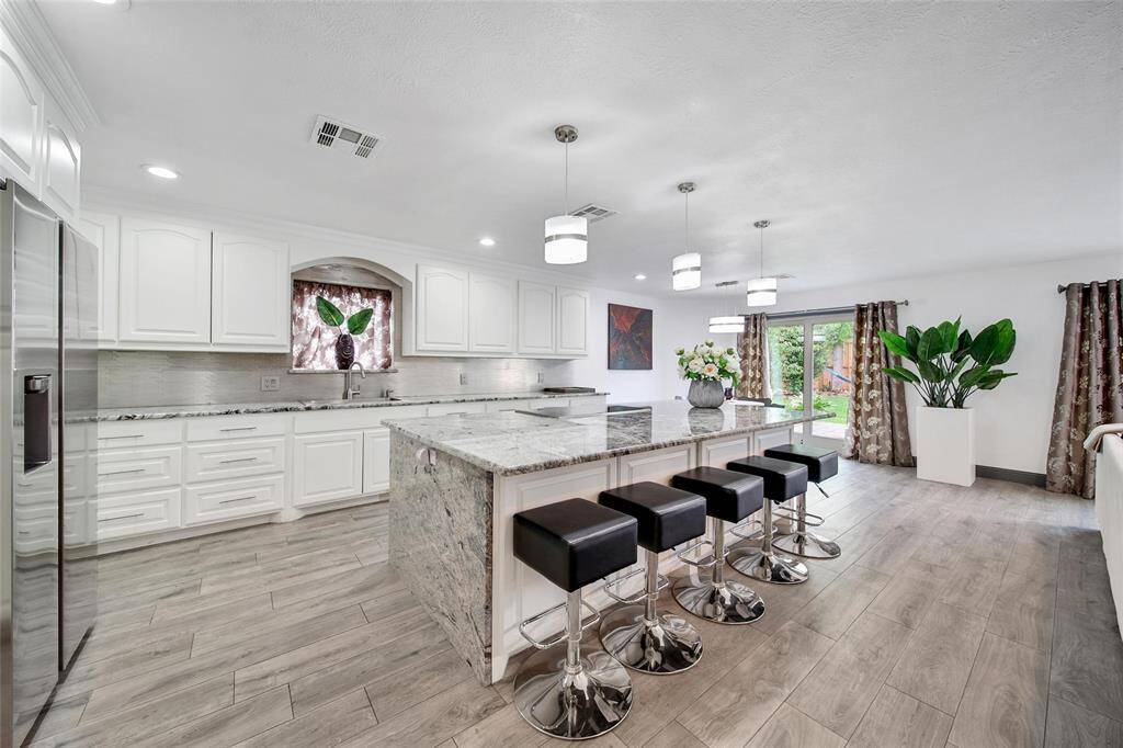 Custom Cabinetry on all shelves and Island in the kitchen with upgraded tier 3 Granite countertops.