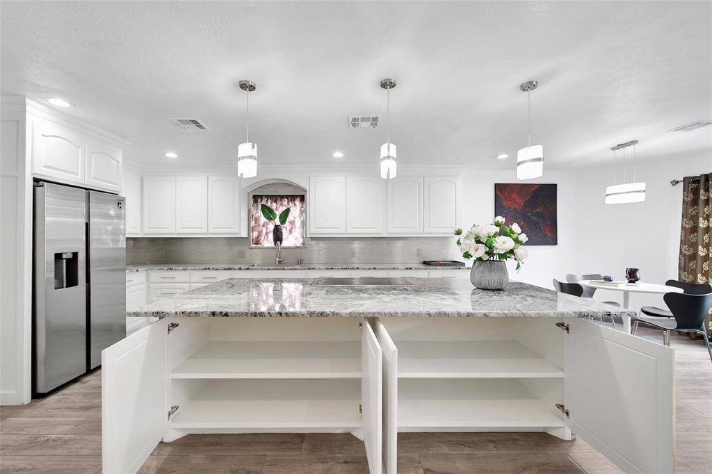 Plenty of storage space on both sides of the island stovetop area.