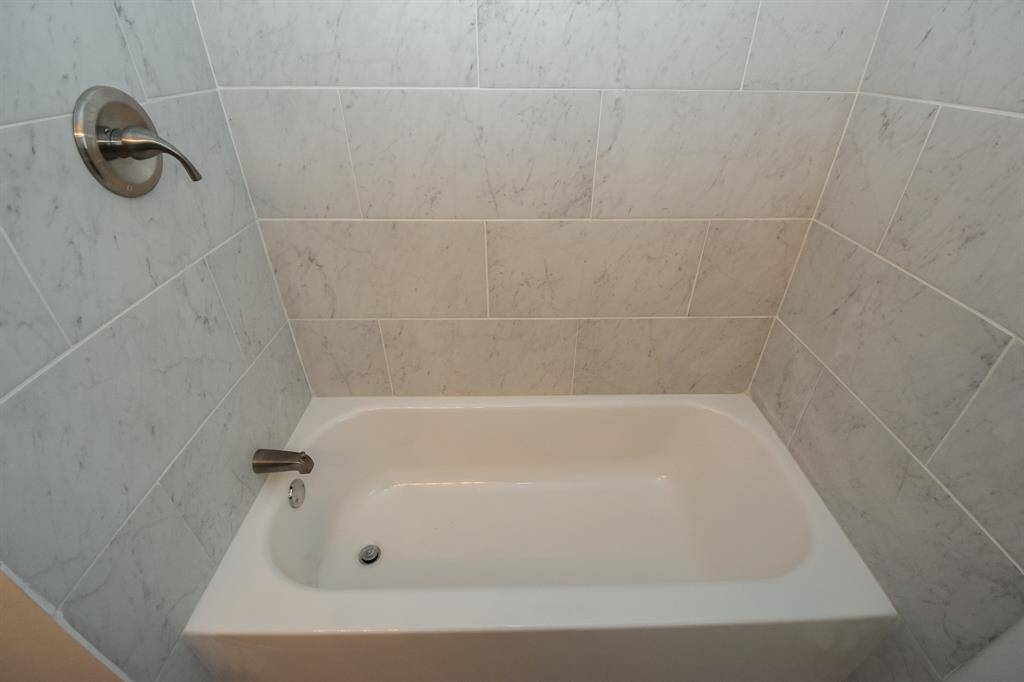 Hall bath with tub and shower.