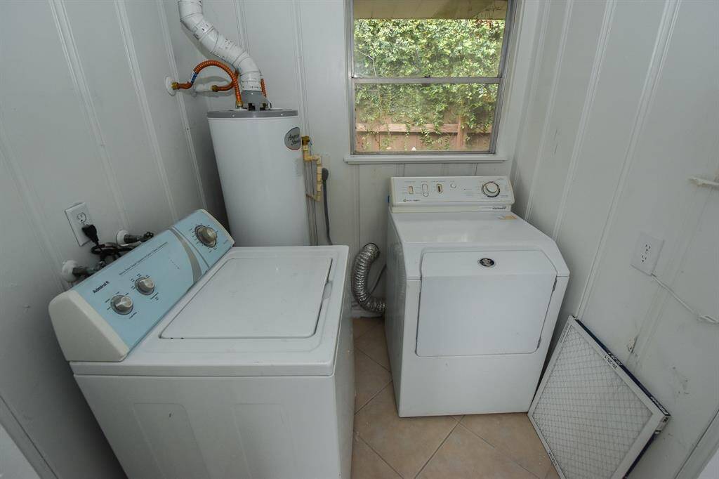 In the south wing of the home there is the utility room with washer and dryer.