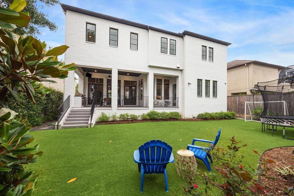 The expansive backyard offers a pristine turf lawn ideal for recreation, lounging, or play, with ample room to accommodate a future pool. Framed by manicured landscaping and tall privacy fencing, this inviting outdoor retreat is perfect for both entertaining and everyday enjoyment.