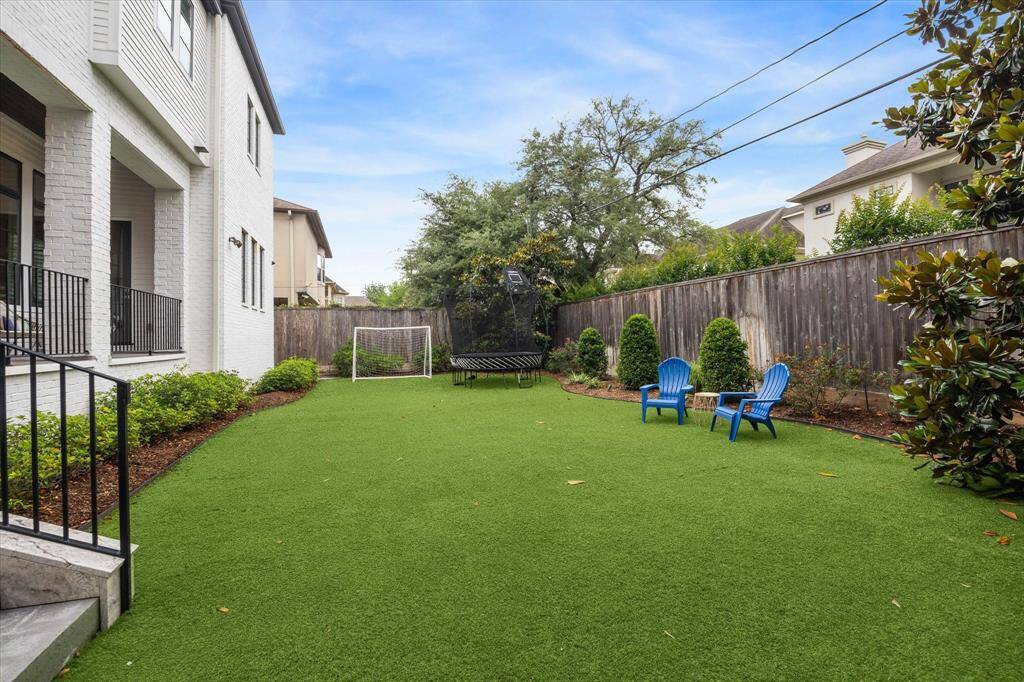 This expansive backyard offers a lush, low-maintenance turf lawn bordered by manicured landscaping, ideal for recreation, relaxation, and entertaining. With generous space to accommodate a pool, this private outdoor retreat invites endless possibilities for customized luxury living.