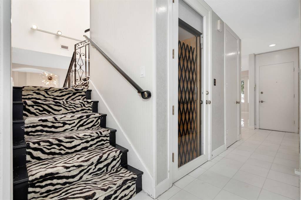 Elevator access and staircase from kitchen area