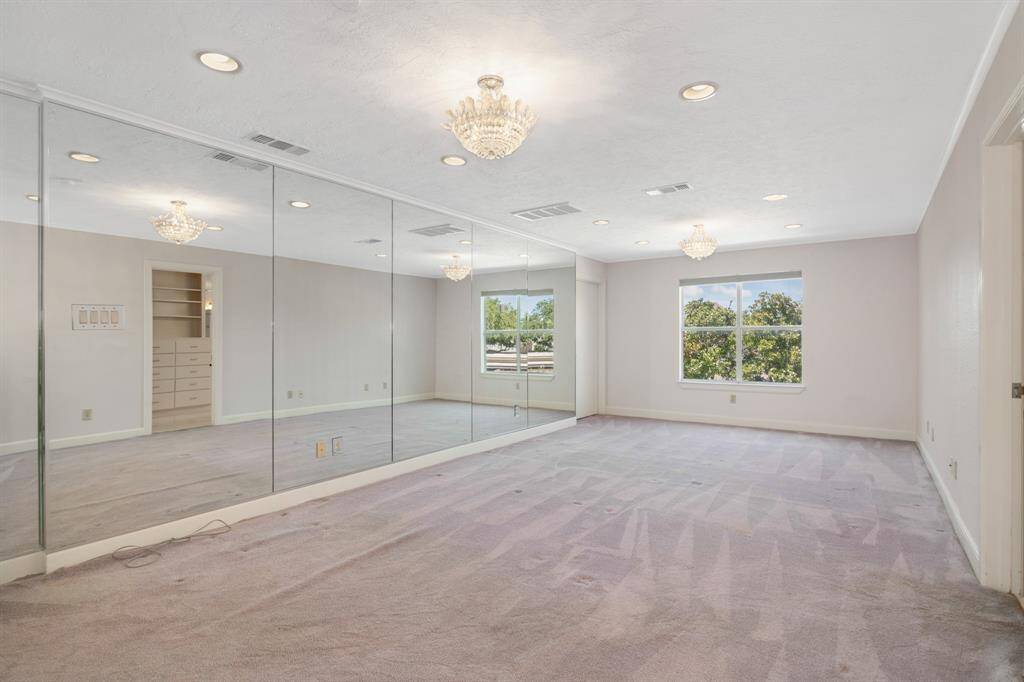 Bedroom #2: This is a spacious, well-lit room featuring wall-to-wall carpeting, mirrored walls that enhance the sense of space, and two elegant light fixtures. Perfect for those looking for a home with a modern touch and open feel. This room has an in suite bath