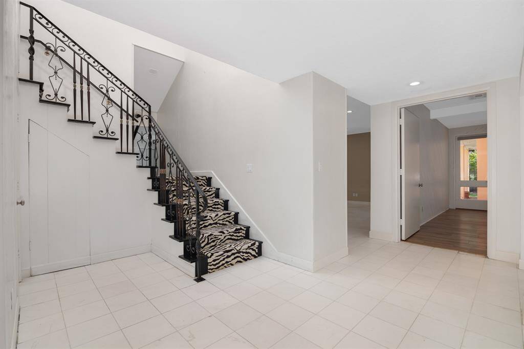 Custom iron staircase centrally located in the home.
